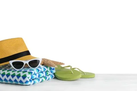 Set of beach accessories on table against white background. Space for text Foto stock