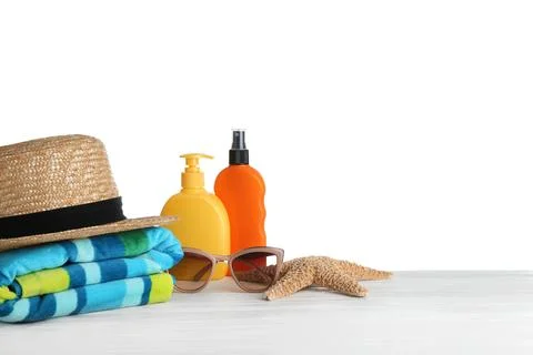 Set of beach accessories on table against white background. Space for text Foto stock