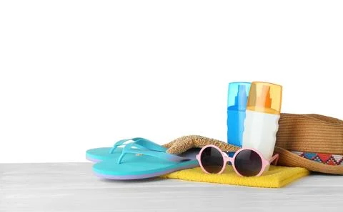 Set of beach accessories on table against white background. Space for text Foto stock