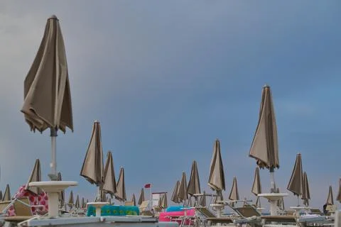 Set of beach umbrellas close. metaphor of the summer is over Stock Photos