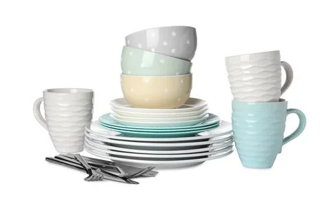 Set of beautiful ceramic dishware and cutlery isolated on white Stock Photos