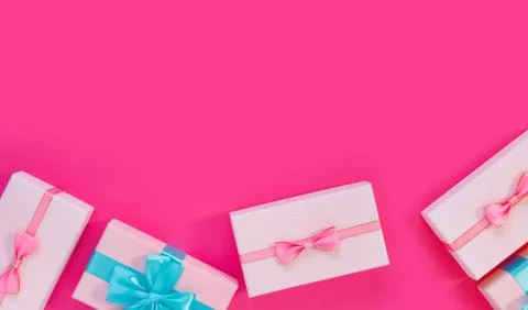 Set of beautiful gift boxes with blue bows on pink background. Holiday sale. Stock Photos