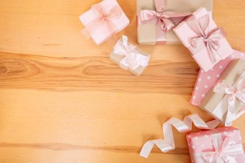 Set of beautiful gift boxes with pink bows on a wooden table. Stock Photos