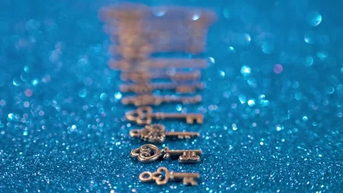 Set of beautiful old style keys, different sizes and types on blue background Stock Footage 297773348