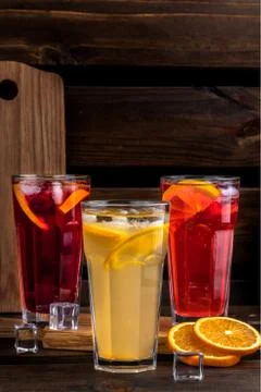 Set of beautiful summer refreshing drinks on a wooden background. three glass Stock Photos