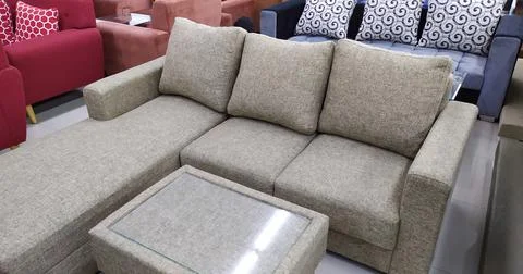 A set of beige sofas made of canvas and a table Stock Photos