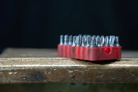 A set of bits for repair. Black background. Plastic case with a red backgroun Stock Photos