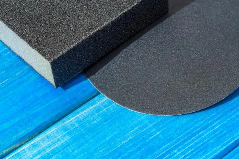 Set of black abrasive tools on blue wooden boards Stock Photos