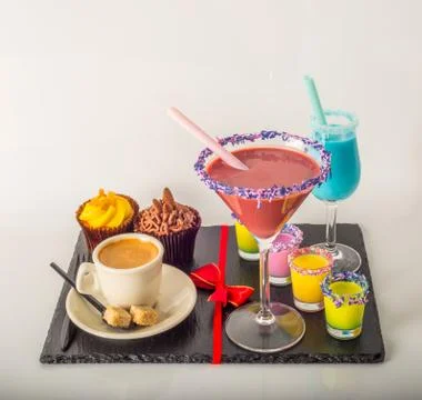 Set of black coffee in a cup, two muffins with a  purple and blue drink Stock Photos