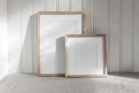 Set of blank vertical and square wooden picture frame mock ups in sunlight Stockfoto's