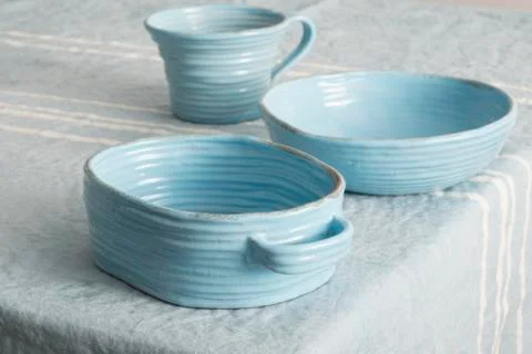 Set of Blue Earthenware on Blue Linen Stock Photos