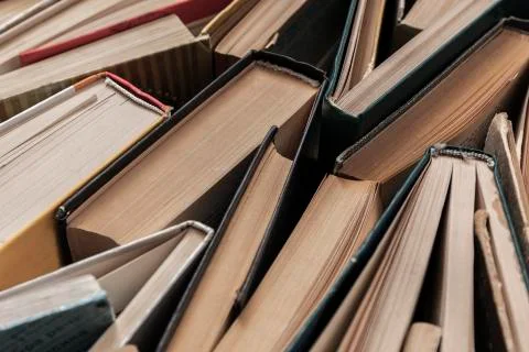 A set of books of different sizes lying on the floor Stock Photos
