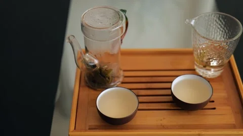 Set for brewing Chinese tea on a tea board. Elite Chinese white tea in bowls Stock Footage 220342245