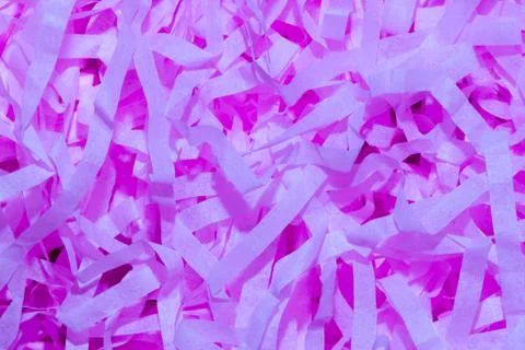 A set of bright fluorescent purple thin confetti paper photographed close-up. Stock Photos