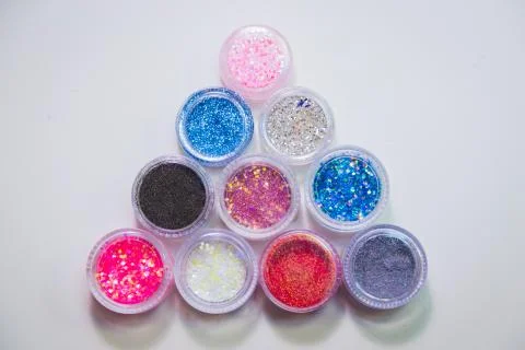 Set of bright glitters in transparent jars Stock Photos