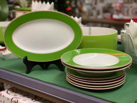 A set of bright plates on a set of kitchen plates on a store shelf. Stack of  Stock Photos