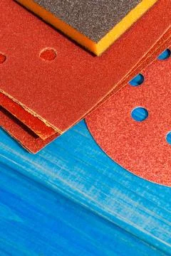 Set of brown abrasive tools on blue wooden boards Stock Photos