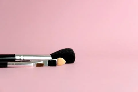 Set of brush makeup tools with pink pastel background Stock Photos