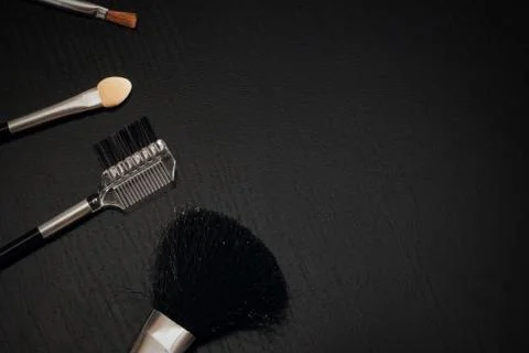 A set of brushes for applying makeup close-up on a dark background Stock Photos