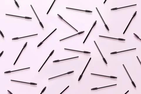 Set of brushes for eyelashes and eyebrows on pink background. Stock Photos