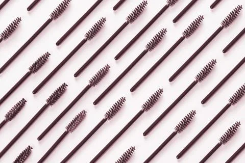 Set of brushes for eyelashes and eyebrows on pink background. Stock Photos