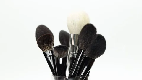 Set of brushes for makeup. Many makeup brushes rotate. Brushes close-up. Stock Footage 128784084