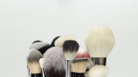 Set of brushes for makeup. Many makeup brushes rotate. Brushes close-up. Stock Footage 128784123