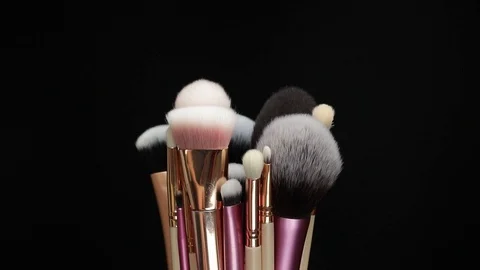 Set of brushes for makeup. Many makeup brushes rotate. Brushes close-up. Stock Footage 128784137