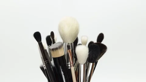 Set of brushes for makeup. Many makeup brushes rotate. Brushes close-up. Stock Footage 129137824