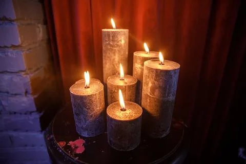Set of burning candles on the table Stock Photos
