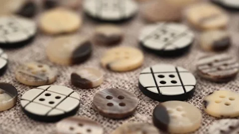 Set buttons in brown beige colors on fabric background burlap. closeup rotation. Stock Footage 257208938