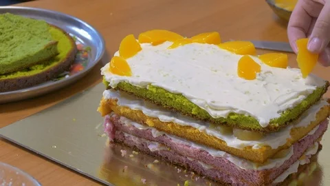 Set cakes of different shapes in the shape of a house and pour in syrup Stock Footage 123577747