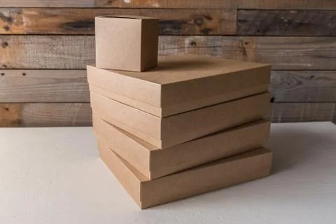 Set of cardboard boxes different sizes on wooden background Stock Photos