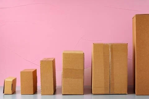 Set of cardboard boxes on pink background Stock Photos