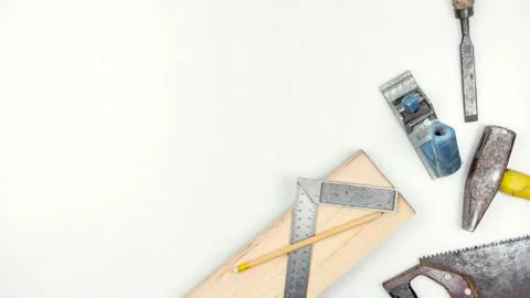 Set of carpentry tools over a white panel with space for text. Stock Photos