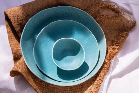 Set of Ceramic Plates on Sackcloth. Stock Photos