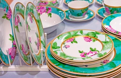 Set of ceramic ware with a flower ornament. Stock Photos
