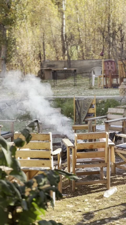 Set of Chairs Surrounded by Nature and fire pit Stock Footage 296199044
