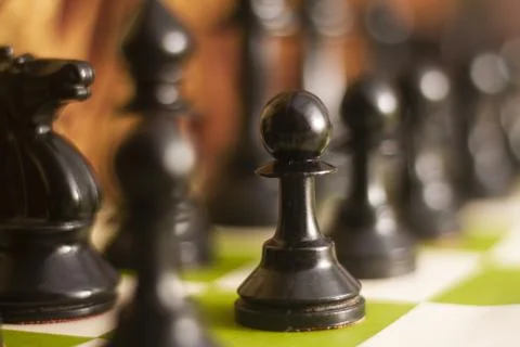 Set chess on a chessboard background focus on pawn Stock Photos