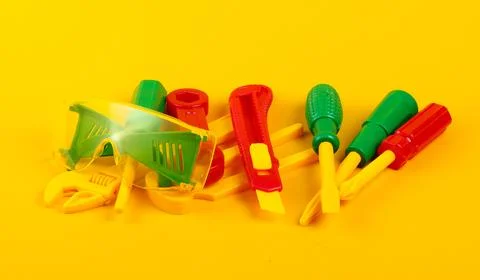 Set of children's toy work tools on yellow background 写真素材