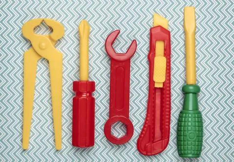 Set of children's toy work tools on a blue background. Flat lay. Top view 스톡 사진