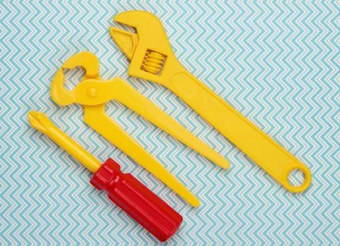 Set of children's toy work tools on a blue background. Flat lay. Top view Stock Photos