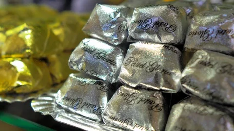 Set of chocolates wrapped in gold and silver paper Stock Footage 124379767