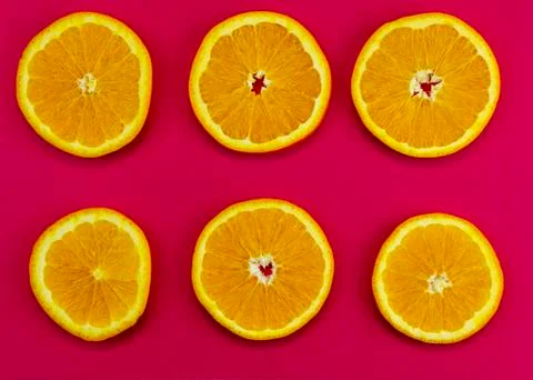 Set of chopped oranges on a pink background Stock Photos