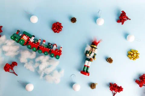 Set of christmas decorations with nutcracker, toy train and balls Stock Photos