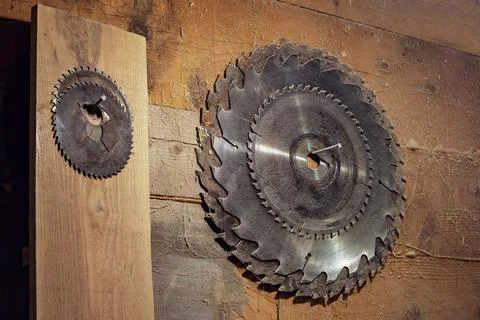 Set of circular saw blades hangs on a wooden wall in the carpentry workshop.. Stock Photos