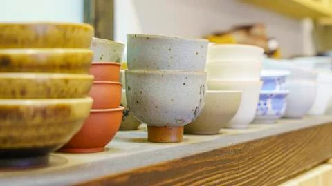 Set of clay cups in tea store. Shop of traditional tea crockery. Stock Photos