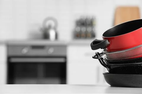Set of clean cookware on table in kitchen. Space for text Stock Photos