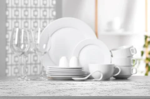 Set of clean dishware, focus on empty stone table Stock Photos