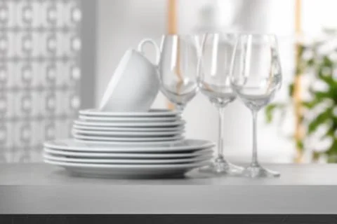 Set of clean dishware, focus on empty stone table Stock Photos